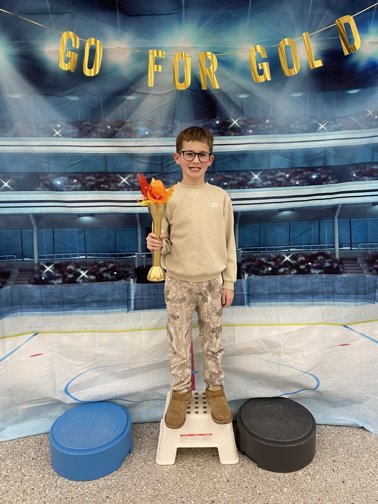 elementary student holding torch