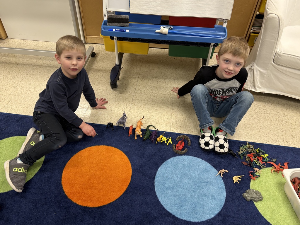 kindergarteners playing with dinosaur figures