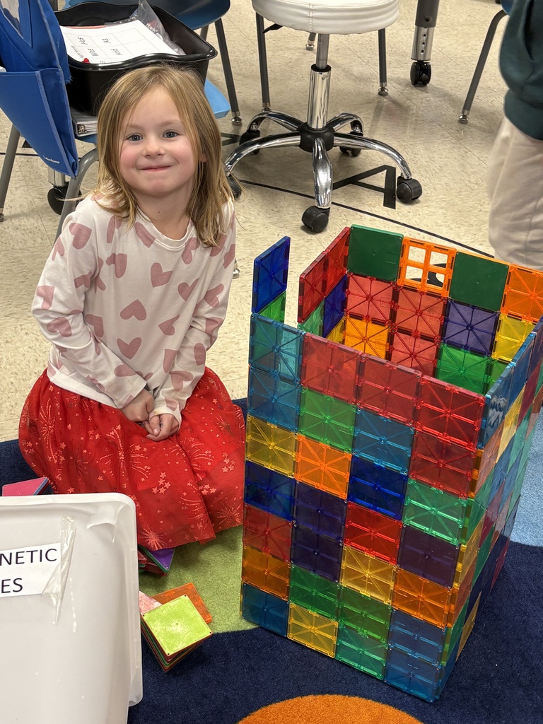 kindergartener playing with magnatiles