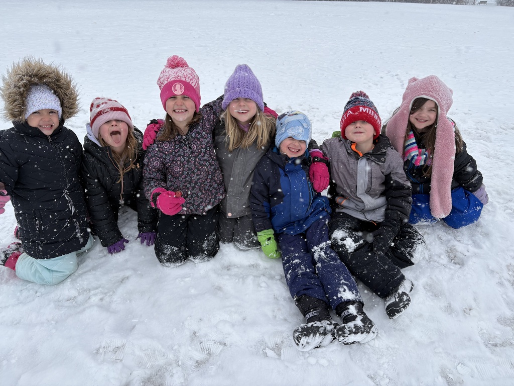students playing in the snow together