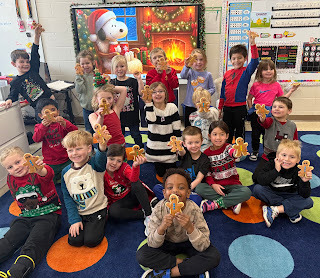 group of kindergarten students holding gingerbread cookies