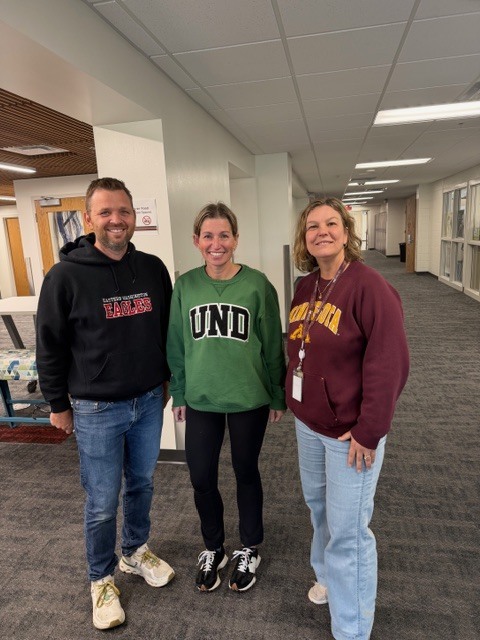 students wearing college shirts on decision day