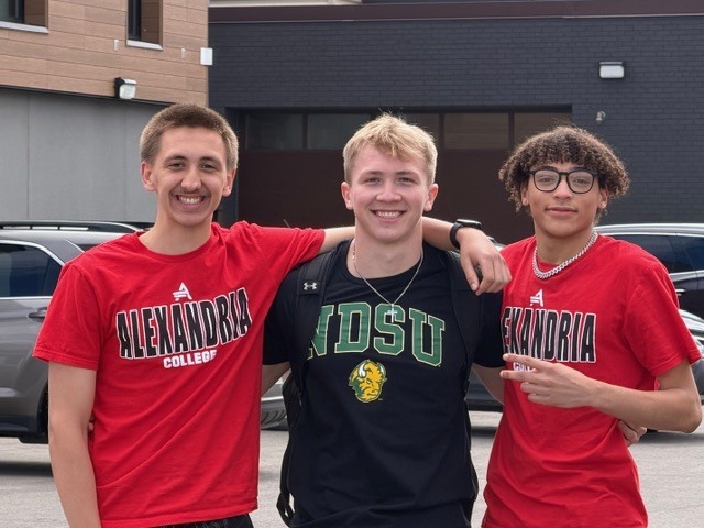 students wearing college shirts on decision day