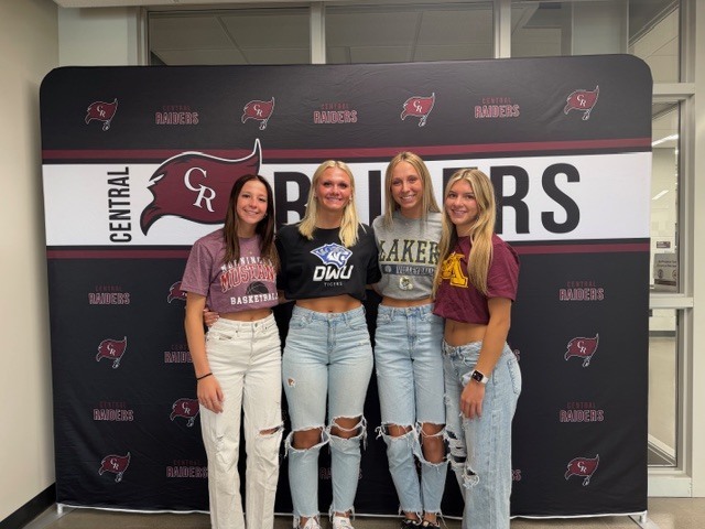students wearing college shirts on decision day