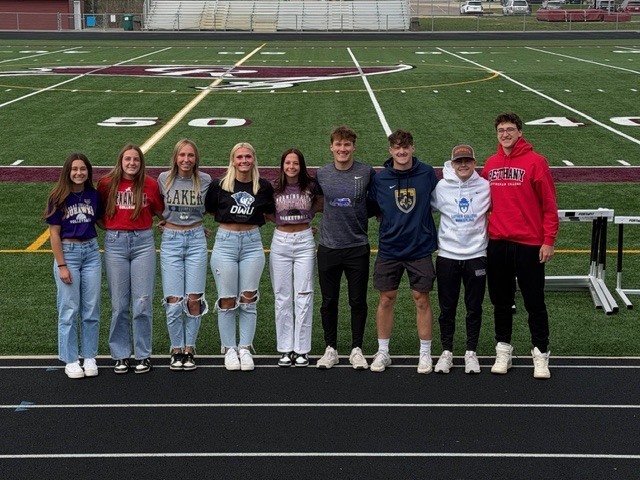 students wearing college shirts on decision day