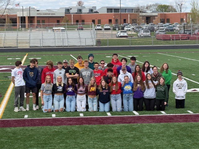 students wearing college shirts on decision day