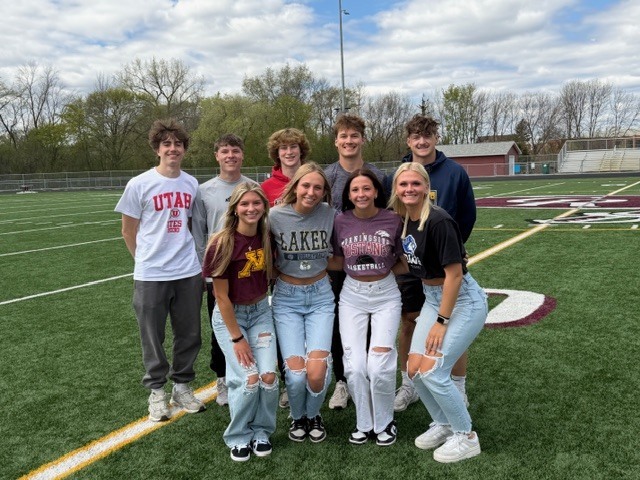 students wearing college shirts on decision day