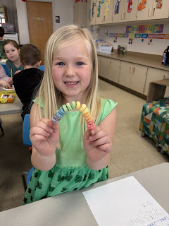 kindergartener counting with cereal