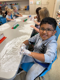 kindergartener playing with shaving cream