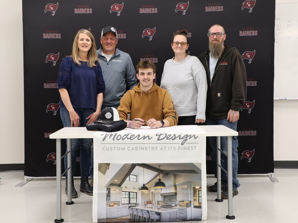 A student with his parents and future employers after committing to work at their company