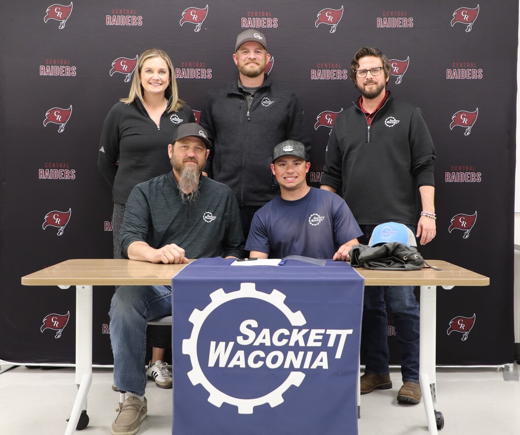 A student signing with an employer to work in the trades
