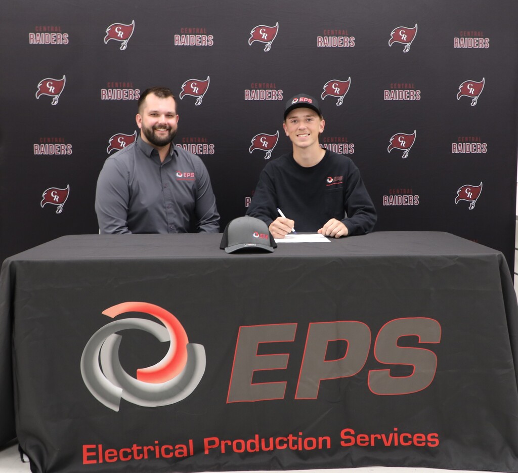 A student signing with an employer to work in the trades