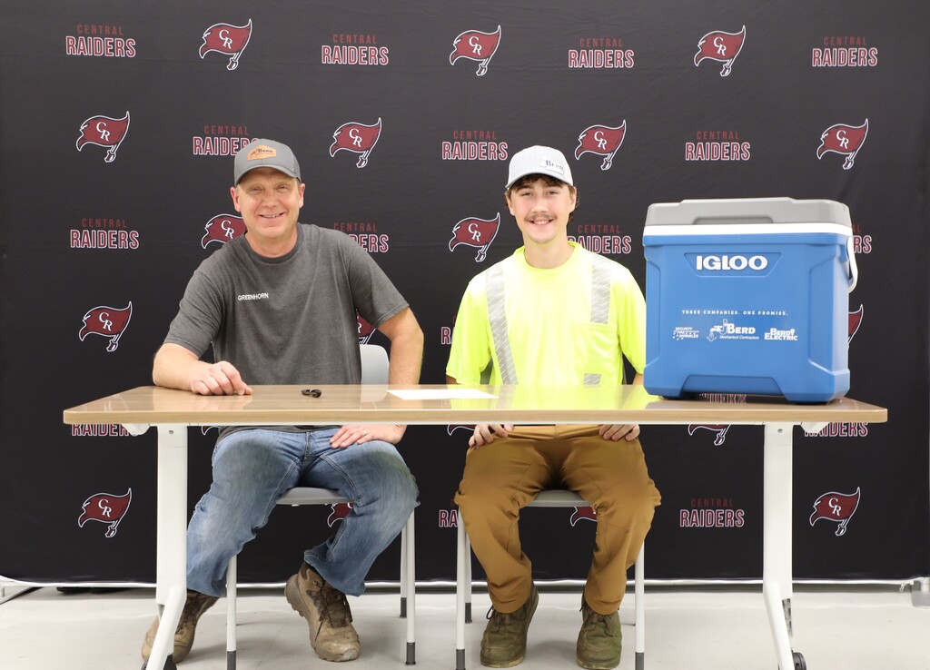 A student signing with an employer to work in the trades