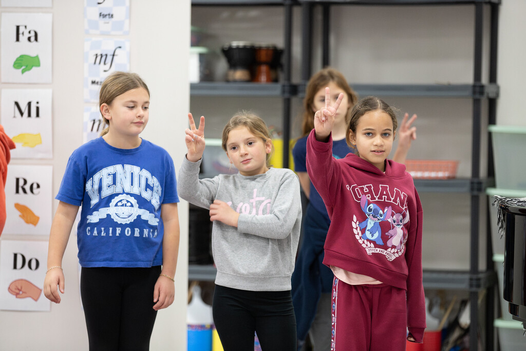 students using peace sign