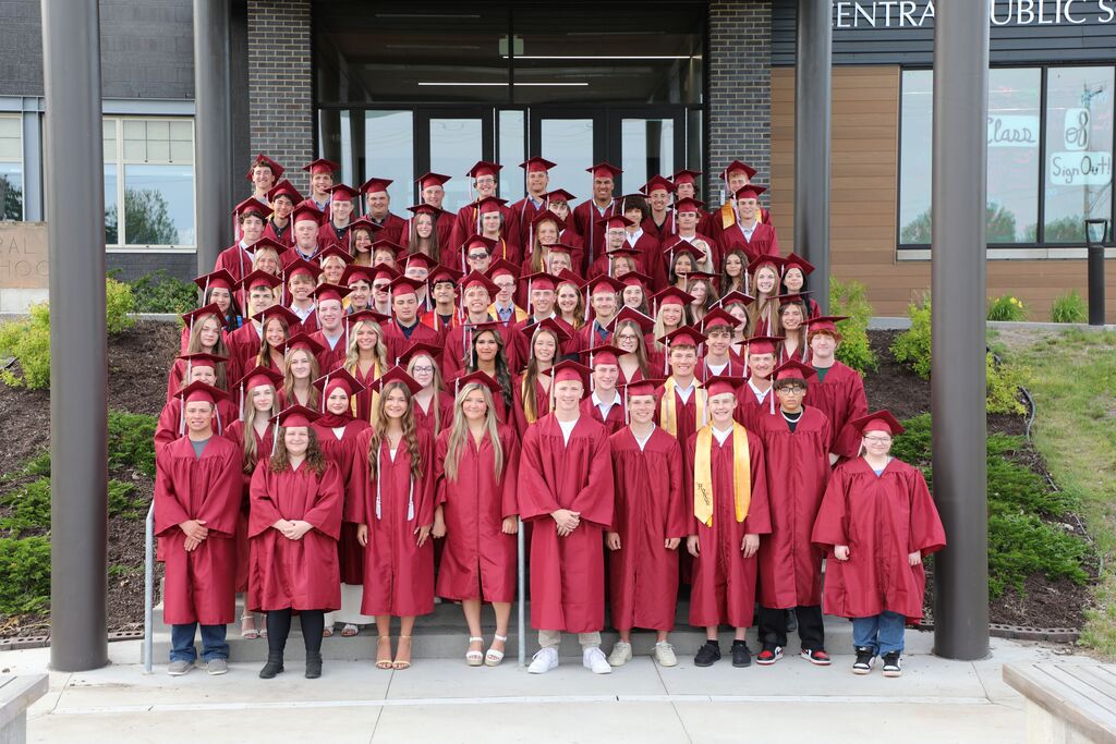 A group picture of the class of 2026 in their cap and gowns outside of school