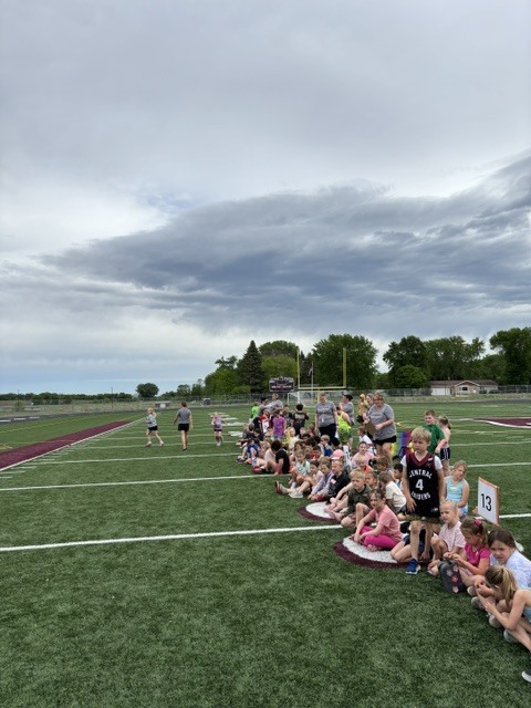 student tug of war on football field