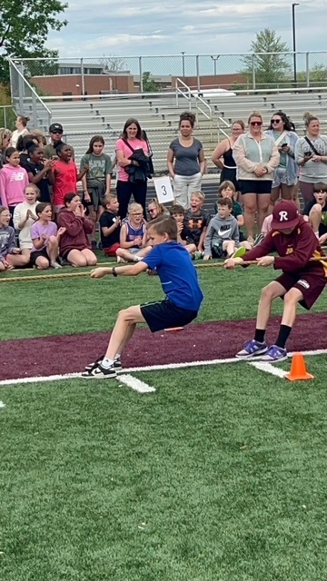 student tug of war on football field