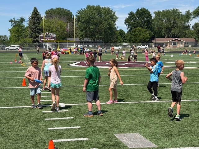 student tug of war on football field