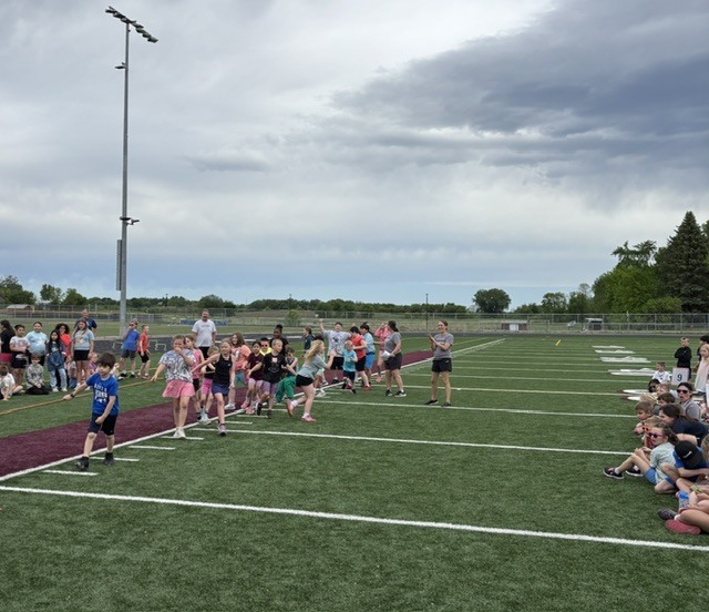 student tug of war on football field