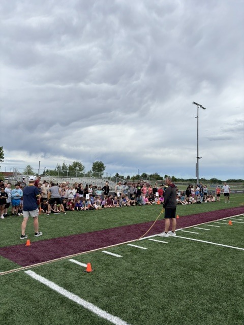 student tug of war on football field