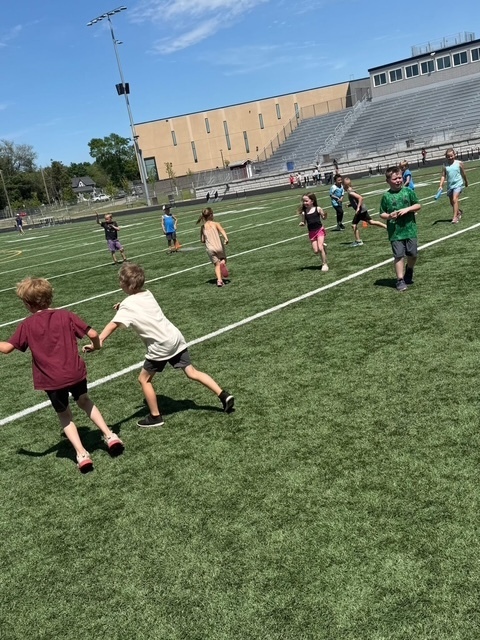 student tug of war on football field