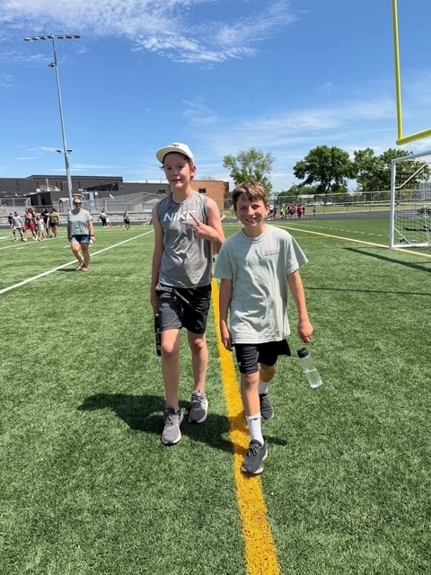 students walking on football field