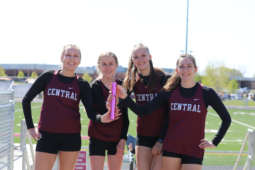girls track relay team holding baton