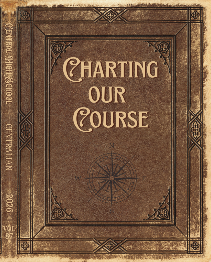 The cover of the yearbook. It looks like an old leather book and has the title "Charting our Course"