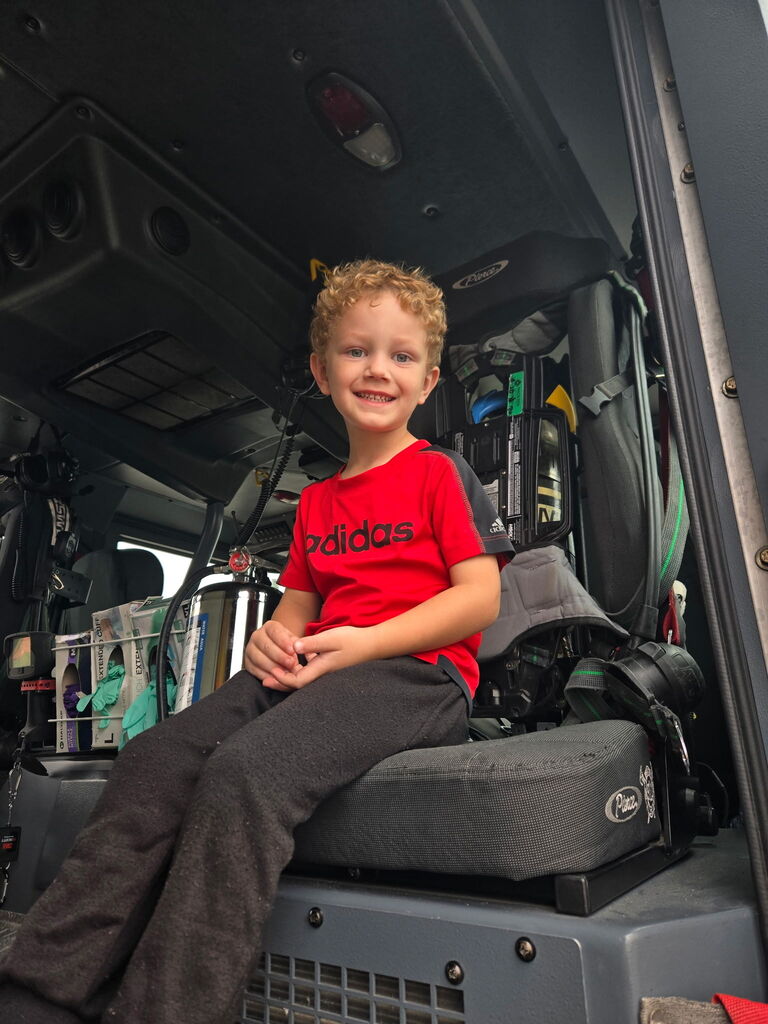 preschoolers sitting in fire truck