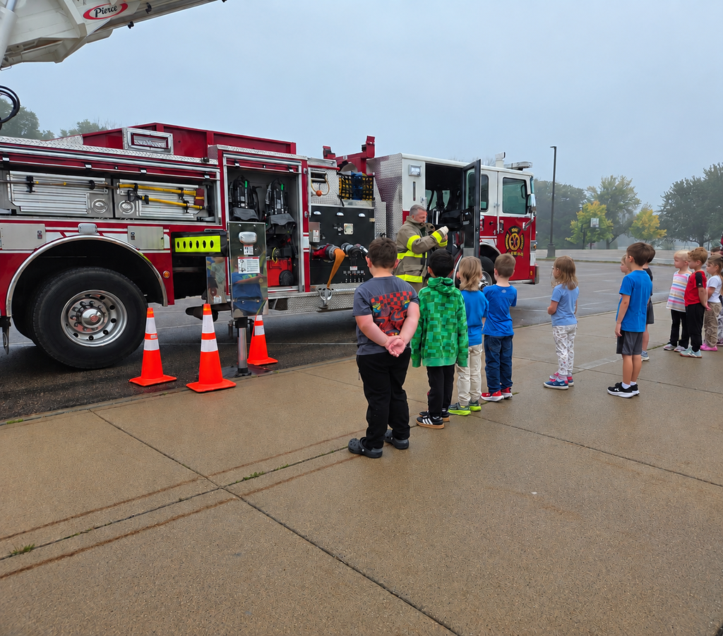 preschoolers standing in front of fire truck