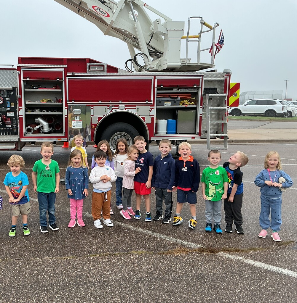 preschoolers standing in front of fire truck