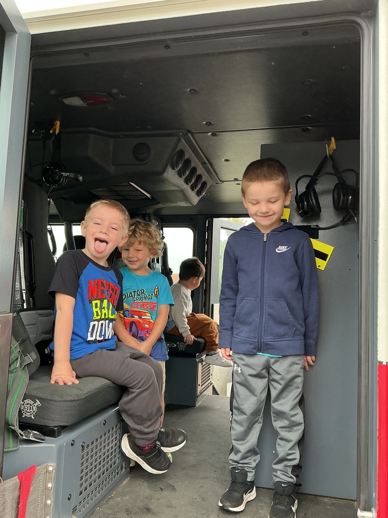 preschoolers sitting in fire truck