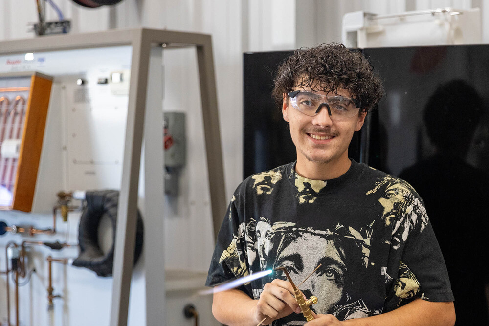 Levi Cartright stands in the HVAC classroom at Central Tech