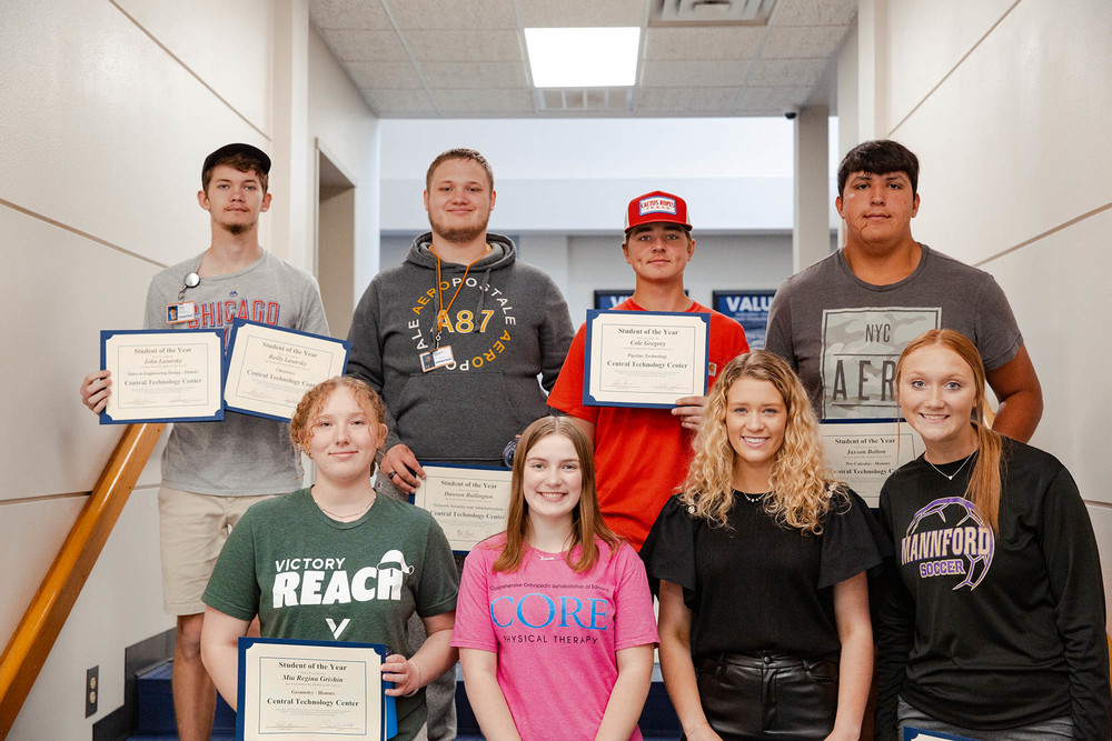 students holding diploma