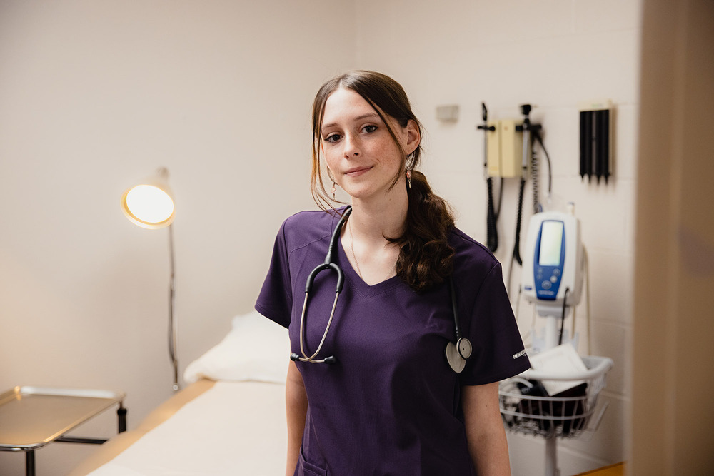 Central Tech Medical Assisting student McKinsey Boothe stands next to a hospital bed