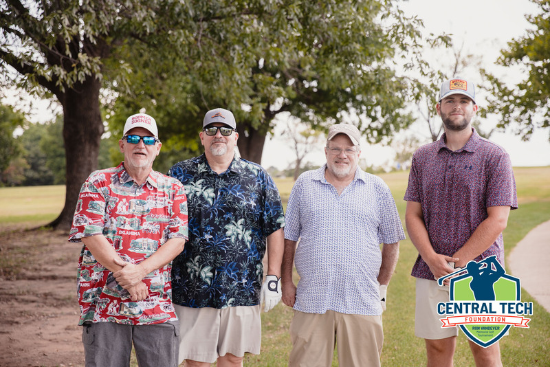 four men representing Crown Auto World at the Central Tech Foundation Golf Tournament