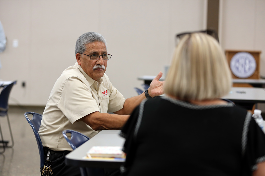 Man and woman engaged in conversation at meeting