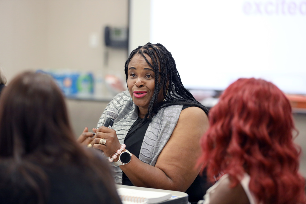 Woman engaged in conversation with tablemates
