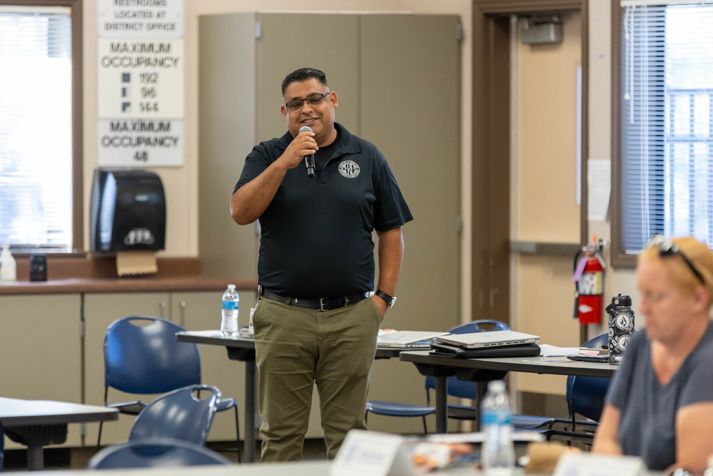 man speaking to a large group of people.