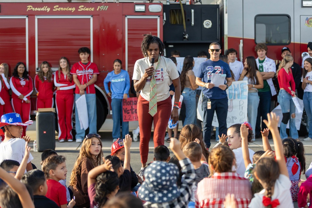 woman speaking to a crowd of students
