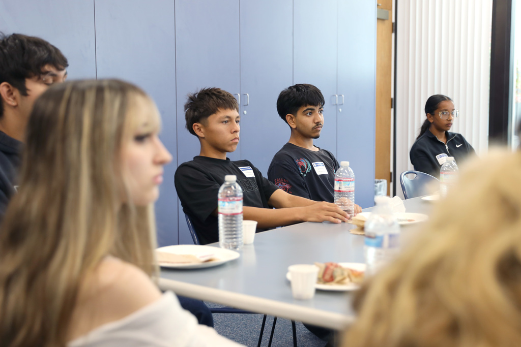 Group of students seated at tables