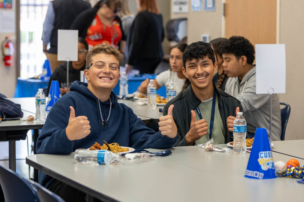 students giving a thumbs up