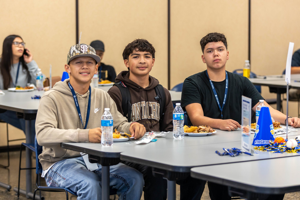 students smiling at a table