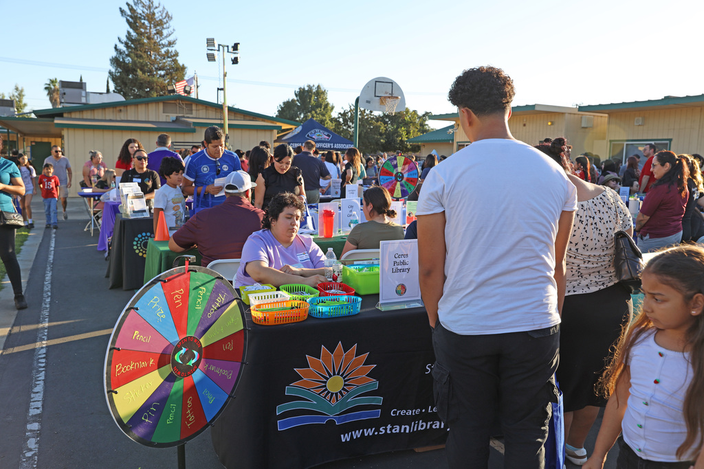 Large crowd visit tables during College & Career Family Night