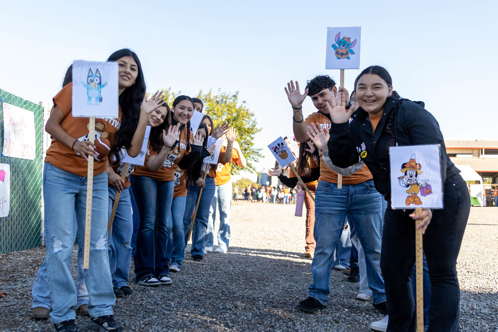 Group of students waving