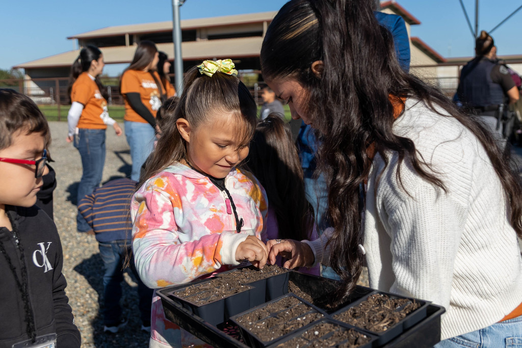 students planting seeds