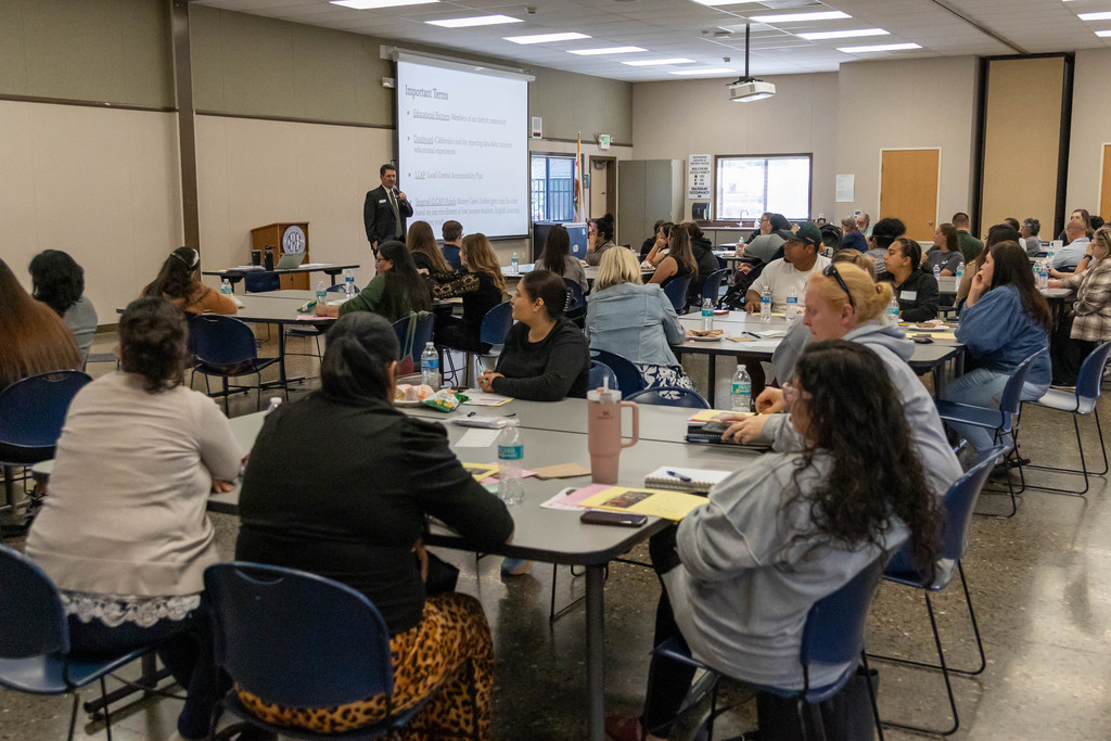 Large group of people listening to a man