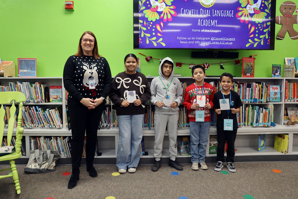 Superintendent with four students who won milestone awards