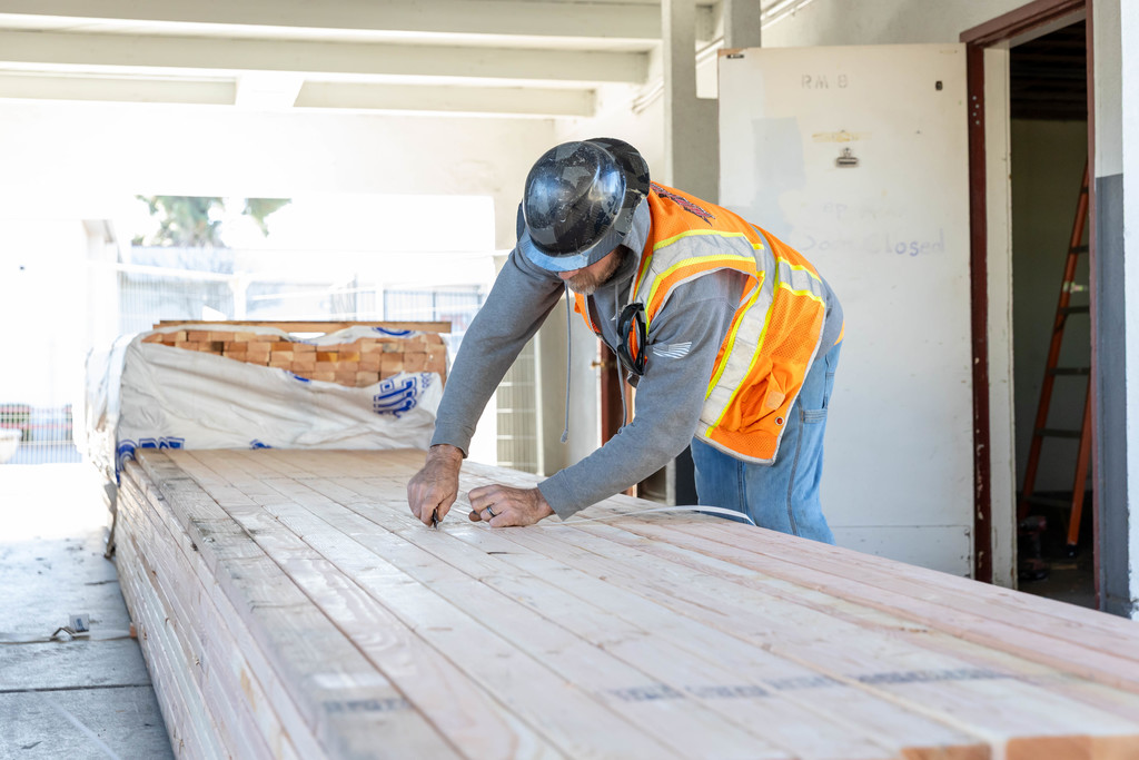 Construction worker cutting a strap