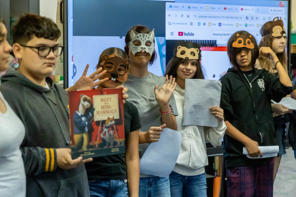 Students in costume acting out a story